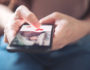 Finger of woman pushing heart icon on screen in mobile smartphone, onlinedating